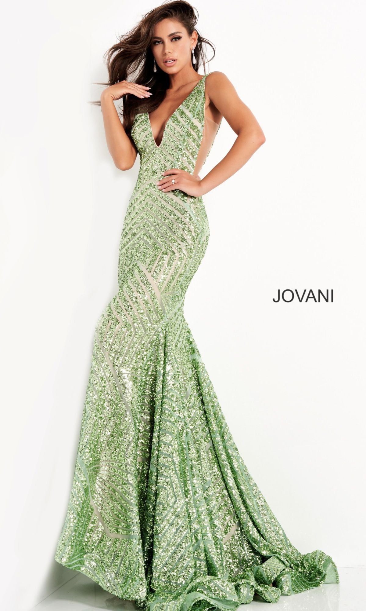 A woman poses against a white background in a stunning Jovani Prom Dress with Striped Sequin Pattern—a fitted, floor-length green gown with a deep V neckline.